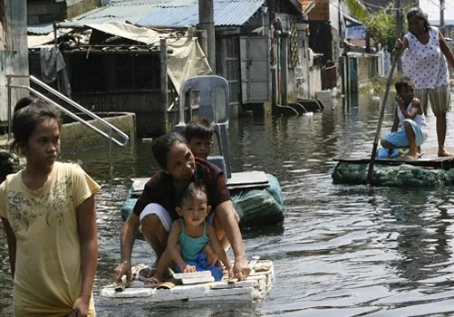 Families on makeshift rafts in a flood